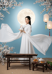Một cô gái trẻ xinh đẹp mặc bộ áo dài trắng tinh khôi, tay áo...